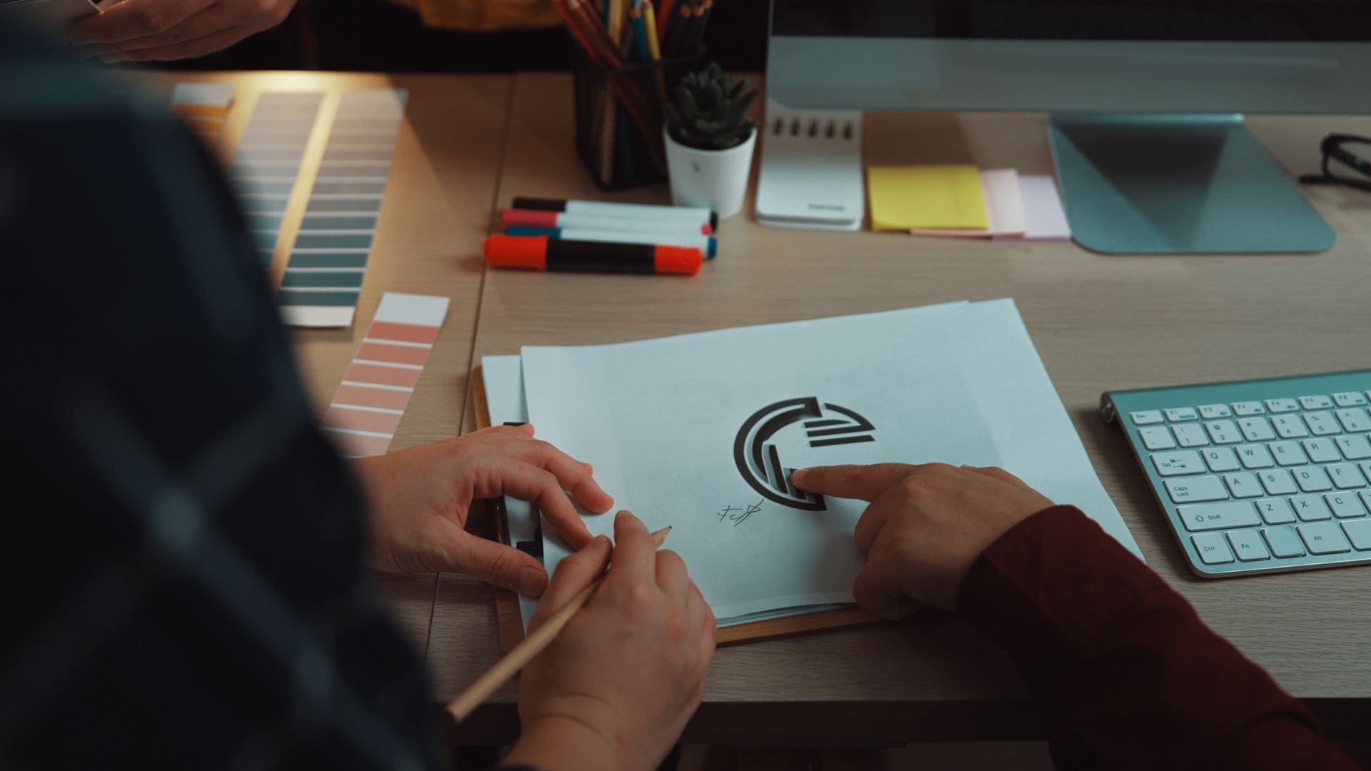 Bad logo design sketch review at design table